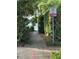 Scenic walking path with verdant greenery leads to tranquil lake, complemented by park signage at 1399 Aloma Ave, Winter Park, FL 32789