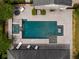 Aerial view showcasing a stunning backyard oasis featuring a pool, spa, patio, and elegant landscaping at 14025 Hench Ln, Orlando, FL 32827