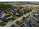This is an aerial view showcasing a vibrant residential neighborhood with colorful homes and well-manicured lawns at 14025 Hench Ln, Orlando, FL 32827
