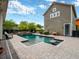 Lush backyard with a sparkling pool, manicured landscaping, and a cozy lounge area, perfect for outdoor enjoyment and relaxation at 14025 Hench Ln, Orlando, FL 32827