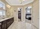 Bathroom featuring a marble countertop, dual sinks, decorative windows, and walk in closet at 14025 Hench Ln, Orlando, FL 32827