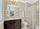 Cozy bathroom featuring a marble countertop, single sink, and shower with a curtain at 14025 Hench Ln, Orlando, FL 32827