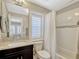 Bathroom with a shower-tub combo, a dark wood vanity, and decorative accents at 14025 Hench Ln, Orlando, FL 32827