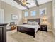 The bedroom features carpeted floors, a beamed ceiling with fan, and ample natural light from multiple windows at 14025 Hench Ln, Orlando, FL 32827