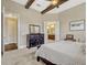 The bedroom features carpeted floors, a beamed ceiling with fan, and access to the ensuite bathroom at 14025 Hench Ln, Orlando, FL 32827