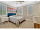 Bedroom features neutral colors, carpet floors, ample natural light and decorative shutters at 14025 Hench Ln, Orlando, FL 32827