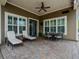 Inviting covered patio with comfortable seating, ceiling fan, and ample space for entertaining, overlooking a beautifully landscaped yard at 14025 Hench Ln, Orlando, FL 32827