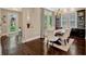 Formal dining room features hardwood floors, a chandelier, wine cabinets, and floor to ceiling windows at 14025 Hench Ln, Orlando, FL 32827