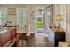 Entryway view showcases wood floors, natural light, and inviting access to the front porch and landscaped yard at 14025 Hench Ln, Orlando, FL 32827