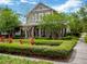 Charming home with a beautifully landscaped front yard, stone accents, a welcoming porch, and mature trees, exuding curb appeal at 14025 Hench Ln, Orlando, FL 32827