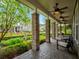 Expansive front porch with stone columns, seating, and well-maintained landscaping, perfect for relaxing outdoors at 14025 Hench Ln, Orlando, FL 32827