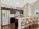 Modern kitchen boasting stainless steel appliances, a center island, and dark wood cabinetry at 14025 Hench Ln, Orlando, FL 32827