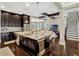 This open concept home features a kitchen island, stainless steel appliances, and dark cabinets at 14025 Hench Ln, Orlando, FL 32827