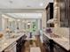This open concept home features stainless steel appliances, dark cabinets, a tile backsplash, and kitchen island at 14025 Hench Ln, Orlando, FL 32827