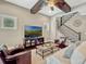 The living room features dark wood floors, a beamed ceiling with ceiling fan, and a staircase at 14025 Hench Ln, Orlando, FL 32827