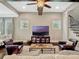 The living room features dark wood floors, a beamed ceiling with ceiling fan, and large windows at 14025 Hench Ln, Orlando, FL 32827