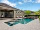 Beautiful backyard pool with a waterfall feature, surrounding patio, and outdoor seating, perfect for relaxation and entertaining at 14025 Hench Ln, Orlando, FL 32827