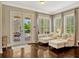 The sun room features hardwood floors, French doors to the patio, and shuttered windows at 14025 Hench Ln, Orlando, FL 32827