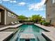 Gorgeous backyard featuring a sparkling swimming pool with a built-in table, lush landscaping, and serene outdoor living at 14025 Hench Ln, Orlando, FL 32827