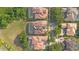 An aerial view of homes featuring tile roofs, screened-in pools, and beautifully landscaped yards at 1450 Belfiore Way, Windermere, FL 34786