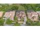 An aerial view of homes featuring tile roofs, screened-in pools, and beautifully landscaped yards at 1450 Belfiore Way, Windermere, FL 34786
