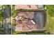 Aerial view showcases tile roof, screened pool, and landscaped yard in this well-maintained property at 1450 Belfiore Way, Windermere, FL 34786