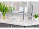 Bathroom vanity with a square vessel sink, modern faucet, and decorative mirror at 1450 Belfiore Way, Windermere, FL 34786