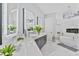 Luxurious bathroom with dual sinks, illuminated mirrors, and a freestanding tub at 1450 Belfiore Way, Windermere, FL 34786
