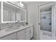 Bathroom featuring a double sink vanity with modern fixtures and a glass-enclosed shower at 1450 Belfiore Way, Windermere, FL 34786