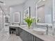 Bathroom featuring double vanity with vessel sinks, decorative mirrors, and custom cabinets at 1450 Belfiore Way, Windermere, FL 34786