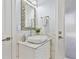 Chic bathroom featuring a sleek vessel sink, unique mirror, and patterned marble accents at 1450 Belfiore Way, Windermere, FL 34786