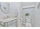 Elegant powder room features a stylish mirror vanity and eye-catching mosaic tile accent wall at 1450 Belfiore Way, Windermere, FL 34786