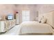 Comfortable bedroom with bright neutral tones, shutters, and stylish furniture at 1450 Belfiore Way, Windermere, FL 34786