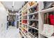Large walk-in closet with custom shelving for shoes and clothing at 1450 Belfiore Way, Windermere, FL 34786