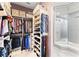 Walk-in closet featuring built-in shelving, hanging rods, and a dressing mirror at 1450 Belfiore Way, Windermere, FL 34786