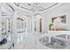 Grand foyer with marble floors, columns, and elegant white piano at 1450 Belfiore Way, Windermere, FL 34786
