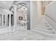 Grand foyer showcases high ceilings, marble flooring, and a staircase leading to the next level at 1450 Belfiore Way, Windermere, FL 34786