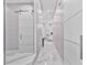 Bright hallway featuring a sliding barn door and marble tile at 1450 Belfiore Way, Windermere, FL 34786
