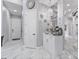 Hallway featuring marble floors, white trim, and a built-in coffee bar at 1450 Belfiore Way, Windermere, FL 34786