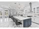 Modern kitchen with a large island, pendant lighting, and seamless flow to the living area at 1450 Belfiore Way, Windermere, FL 34786