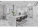 Bright, modern kitchen with a waterfall island, pendant lighting, and stainless steel appliances at 1450 Belfiore Way, Windermere, FL 34786