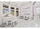Bright living area showcases white piano, accent chairs, and contemporary chandelier at 1450 Belfiore Way, Windermere, FL 34786