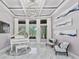 Bright living room featuring a Yamaha piano and large windows with views of the backyard at 1450 Belfiore Way, Windermere, FL 34786