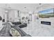 Open-concept living room with a modern sofa, fireplace, and a view of the kitchen area at 1450 Belfiore Way, Windermere, FL 34786