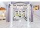 Grand living room with a piano, large windows, elegant columns, and an open layout at 1450 Belfiore Way, Windermere, FL 34786