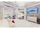 Luxurious main bedroom featuring a tray ceiling, chandelier, and a view of the backyard at 1450 Belfiore Way, Windermere, FL 34786