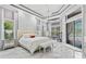 Bright main bedroom with marble floors, textured wall, and a view of the pool at 1450 Belfiore Way, Windermere, FL 34786