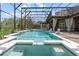 Inviting screened-in pool area with a spa, waterfall feature, and comfortable outdoor living spaces at 1450 Belfiore Way, Windermere, FL 34786