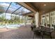 Inviting screened-in pool area with a spa, waterfall feature, and comfortable outdoor living spaces at 1450 Belfiore Way, Windermere, FL 34786