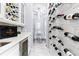 Modern wet bar with wine storage and a view into the elegant dining area at 1450 Belfiore Way, Windermere, FL 34786